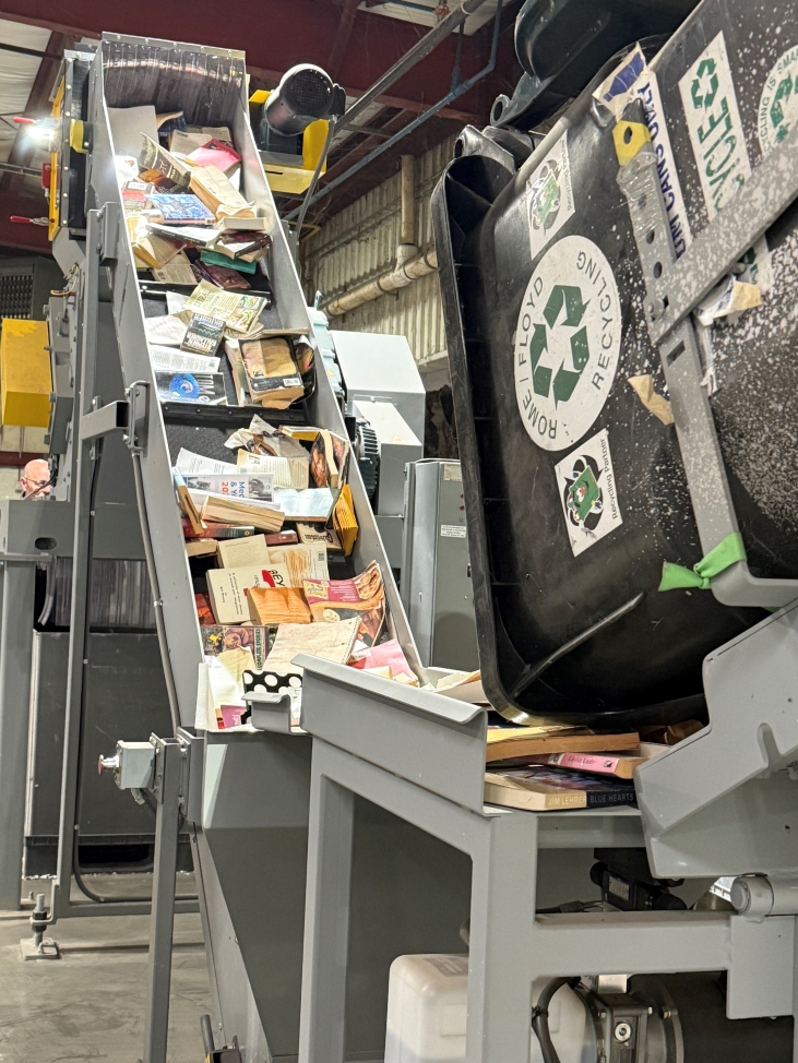 Rome-Floyd Recycling Center shredder showing paper and textbooks being carried up on a belt to be shredded